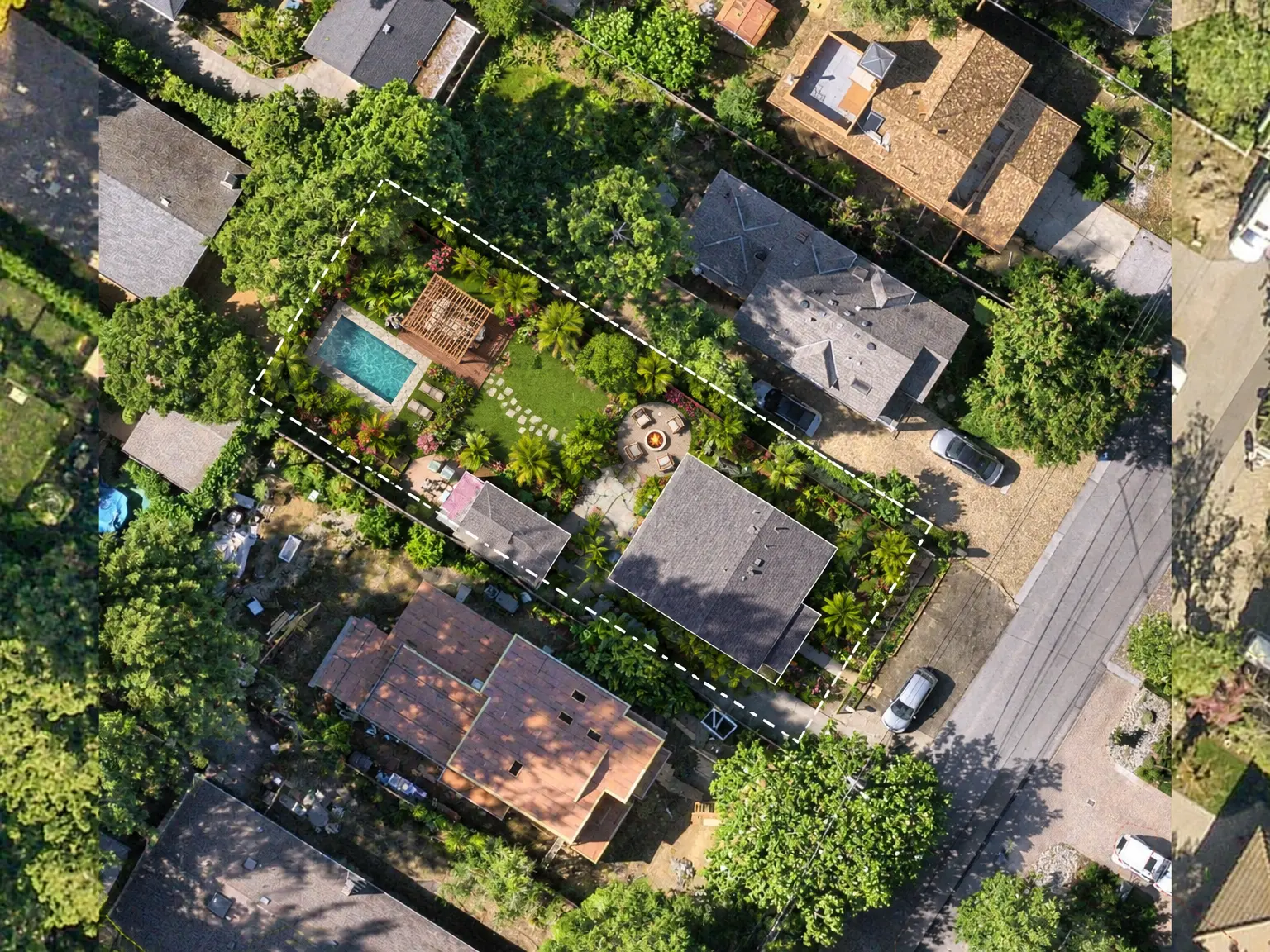 Daylight top-down aerial render of a residential property with a turquoise rectangular pool, lounge chairs, a wooden pergola, a circular fire-pit patio, a stepping-stone path, and perimeter beds of palms and flowering shrubs under mature trees.
